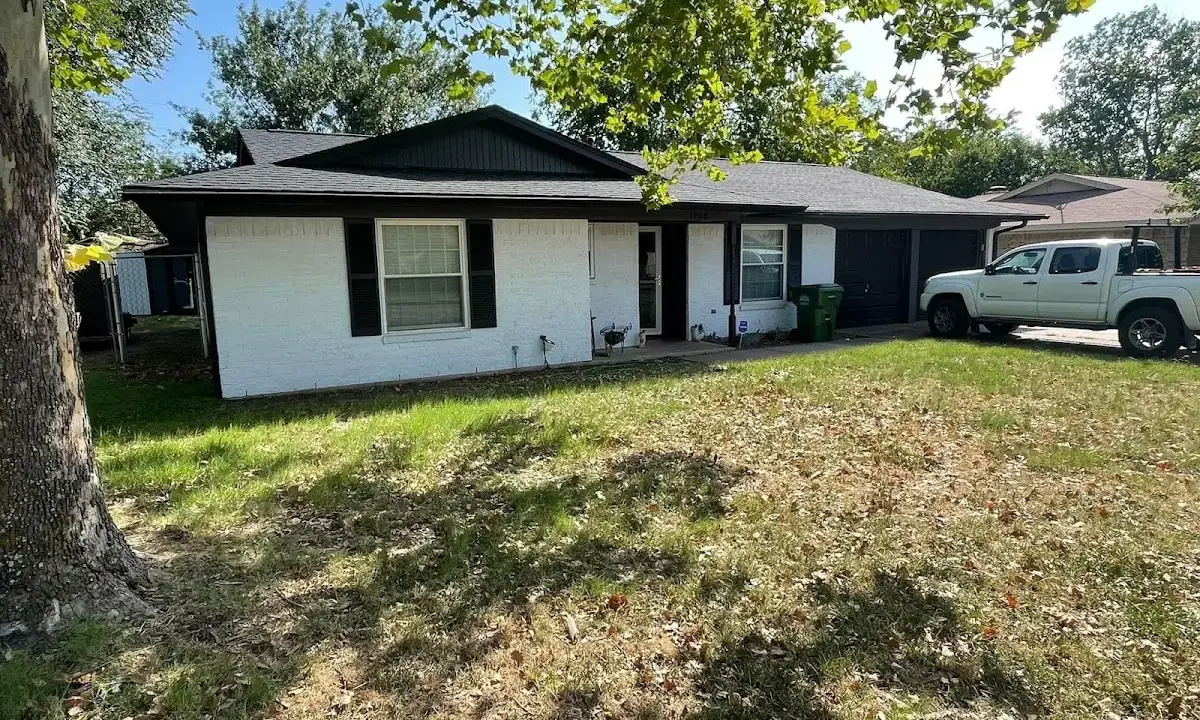 Professional roofing crew working on a residential roof in Hudson